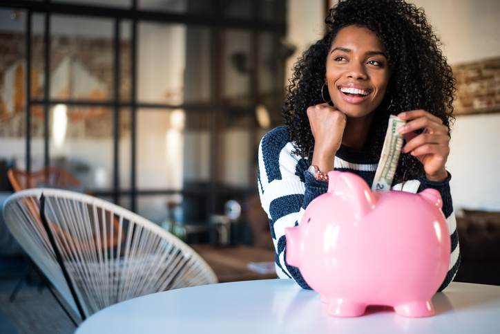 Black woman with saving piggy bank Black woman with saving piggy bank