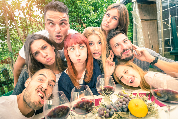 Best friends taking selfie outdoor at winery tasting wine