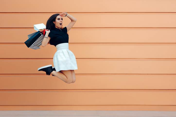 Surprised Woman Running With Shopping Bags in Summer Sale Season Surprised Woman Running With Shopping Bags in Summer Sale Season