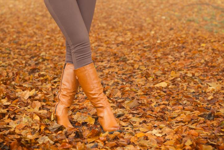 Closeup of woman legs in brown boots. Fall fashion Closeup of woman legs in brown boots. Fall fashion