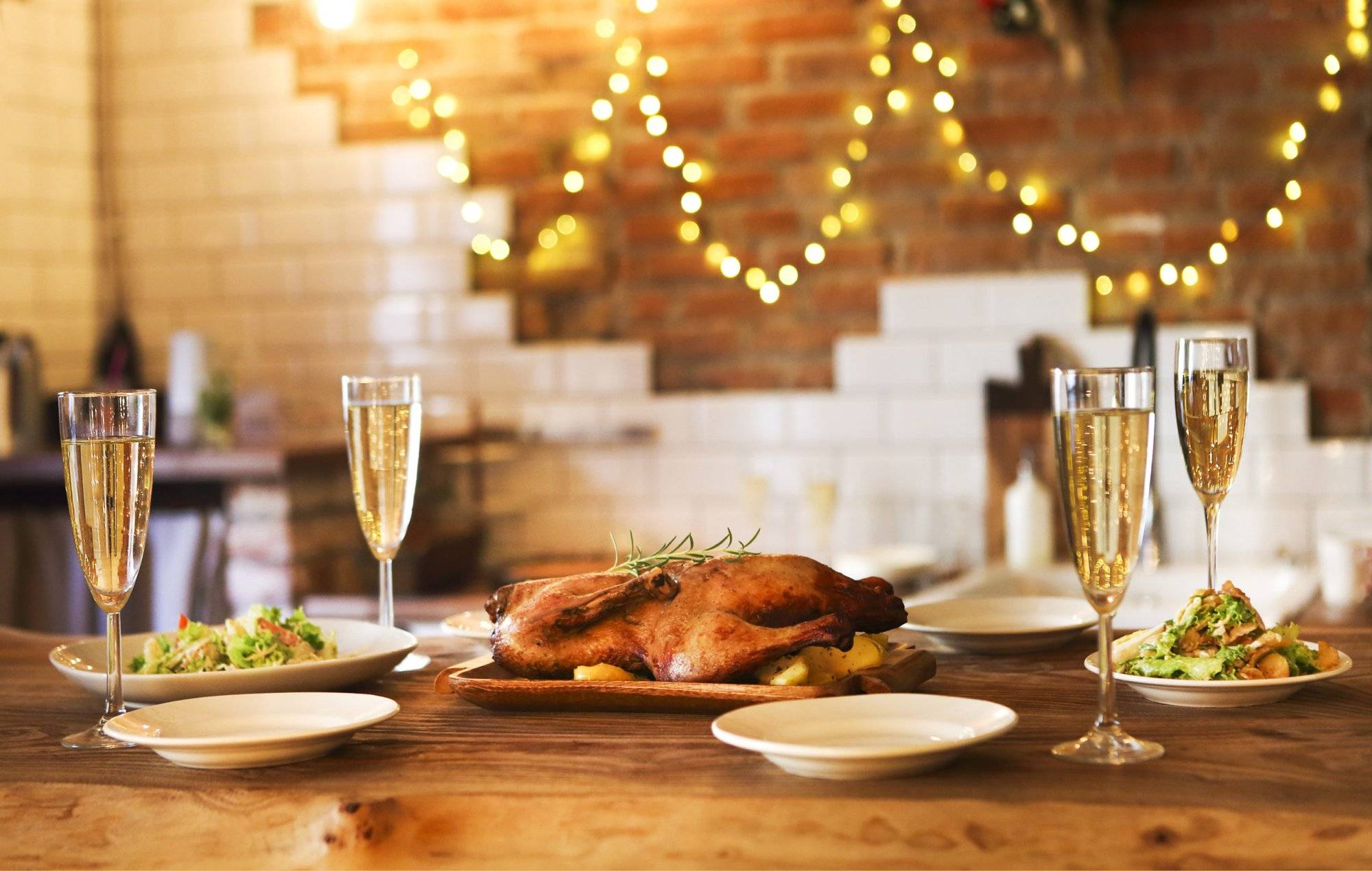 Winter holiday family dinner with roast poultry and champagne Celebrate with Delicious New Year's Eve Food in Frisco