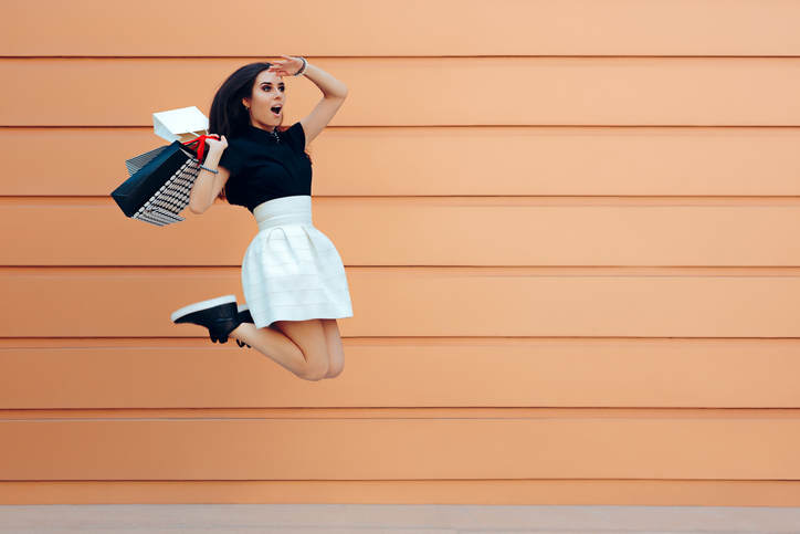 Surprised Woman Running With Shopping Bags in Summer Sale Season