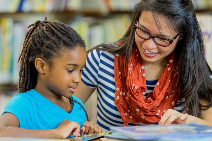 Teacher Reading with a Student